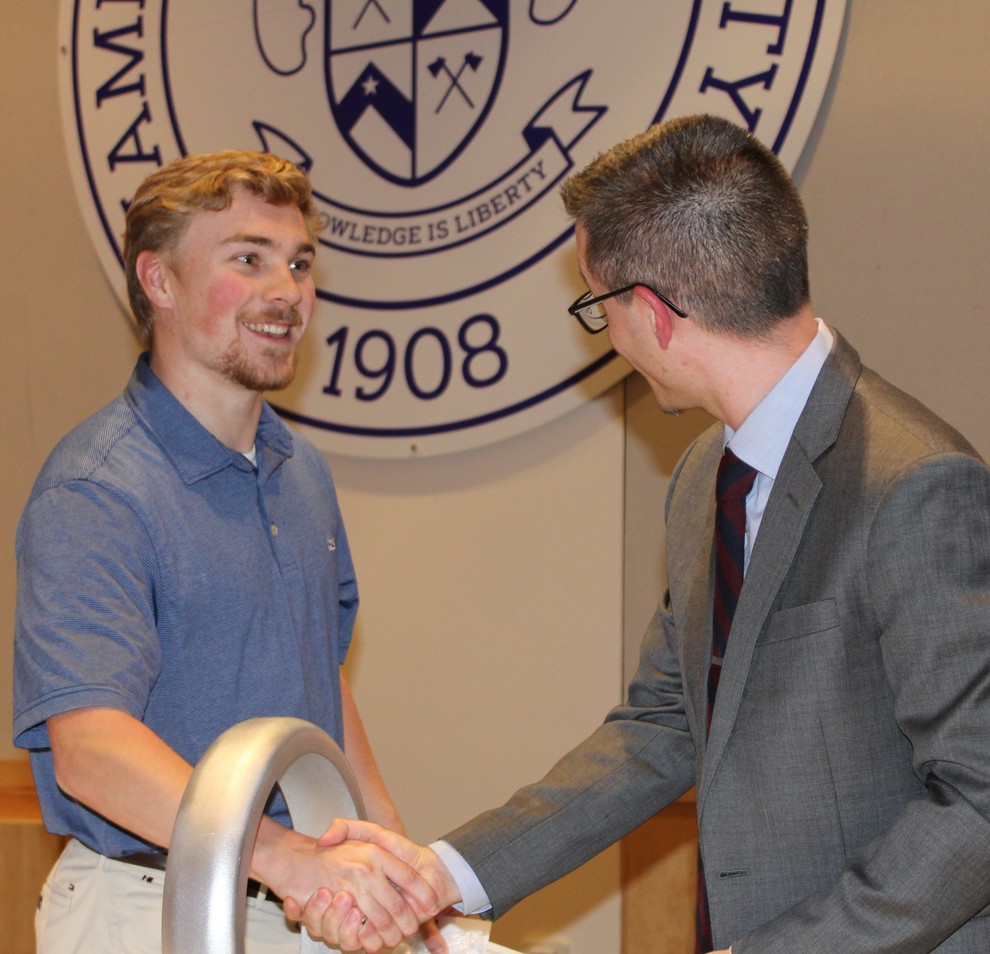 A graduating senior shakes hands during the Order of the Engineer ring ceremony
