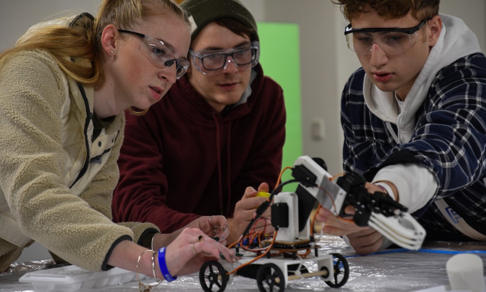 Second-year engineering students building a robotic-arm prototype in ENGR 231