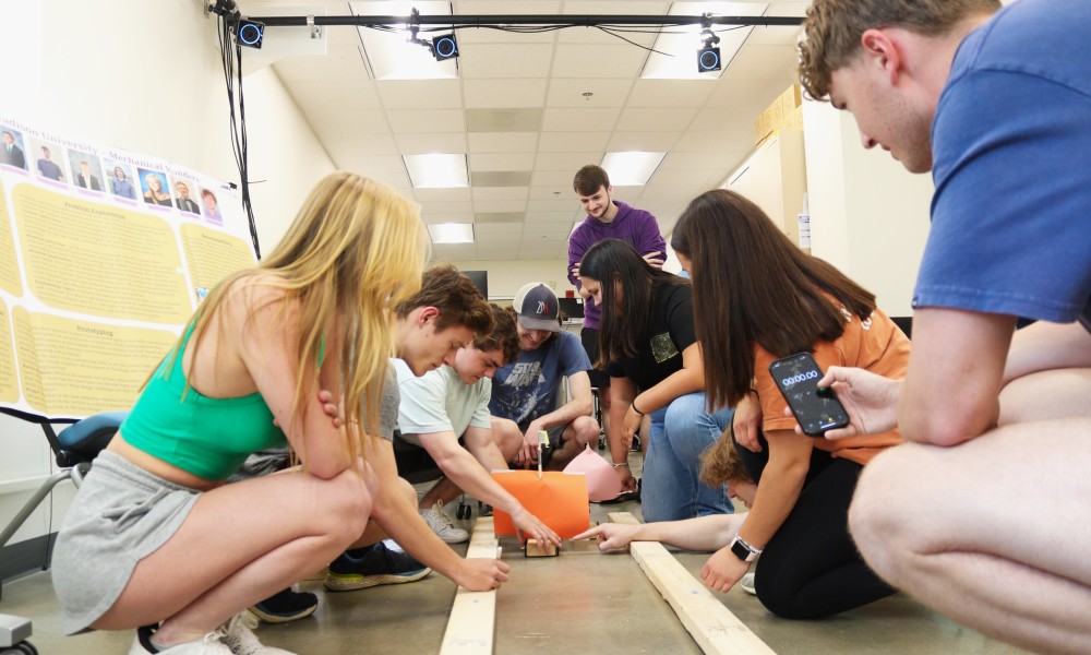 Engineering students building an exhibit for Explore More Discovery Museum